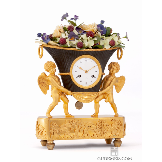 A French Empire ormolu and bronze mantel clock, putti with flower urn, circa 1800