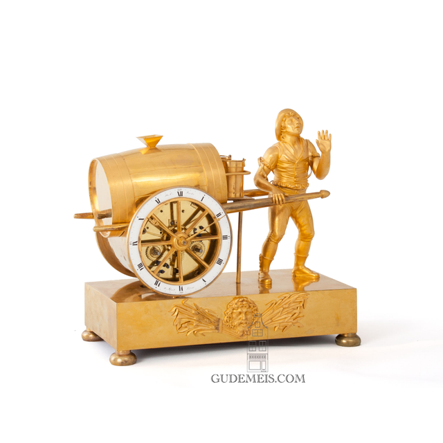 A French Empire gilt bronze mantel clock water seller, circa 1810