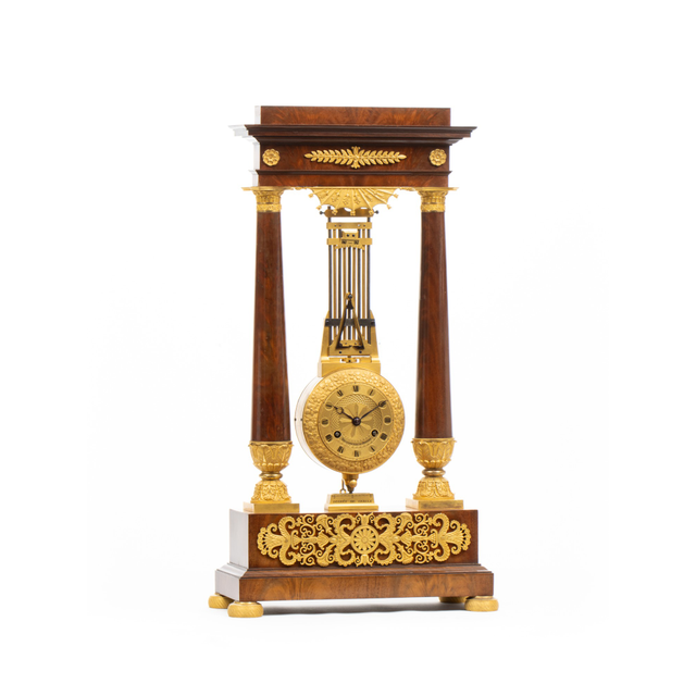 A French late Empire ormolu mounted portico mantel clock with oscillating movement, circa 1825.