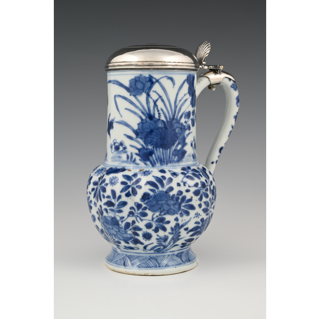 A Chinese porcelain jug with silver lid