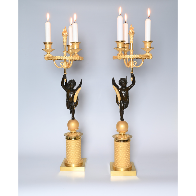 A pair of French Empire patinated bronze and ormolu candelabras