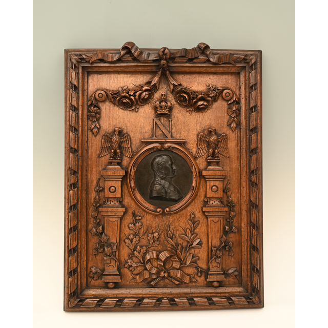 A beautifully carved wooden frame with a bronze  medallion of Napoleon I in the centre