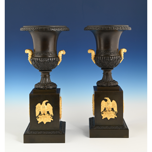 A pair of French Empire patinated bronze and ormolu ewers