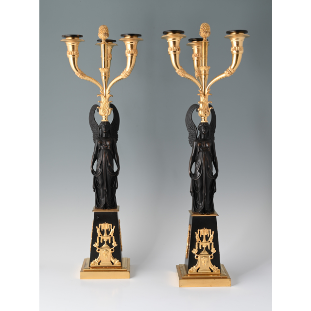A pair of decorative candle holders