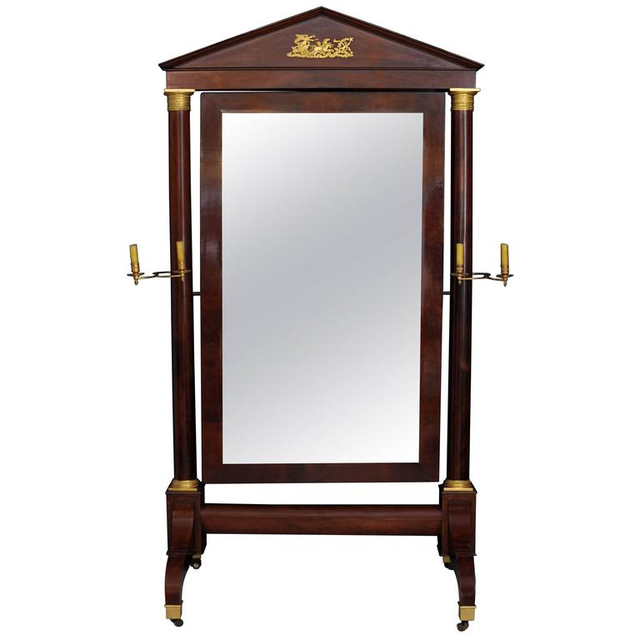 A lovely floral mahogany Empire dressing mirror, with the original candle stick on the columns, circa 1820