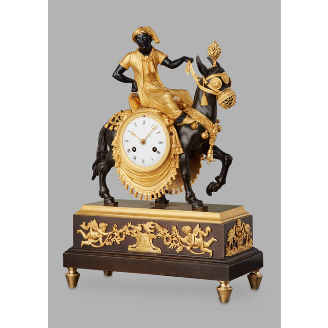 An unusual French ‘Directoire' gilt and patinated bronze mantel clock with young Arab on mule, circa 1800