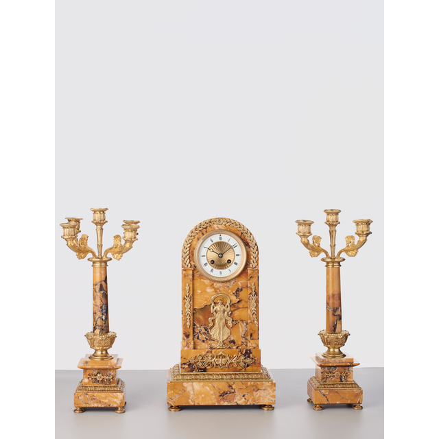 A French sienna marble clock with candle holders, circa 1890