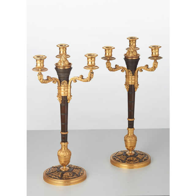 A rare pair of European four-light gilt bronze ‘Directoire’ candlesticks, circa 1810