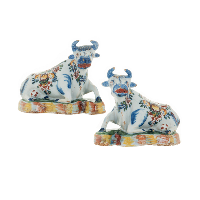 Pair of Polychrome Figures of Recumbent Cows in Dutch Delftware