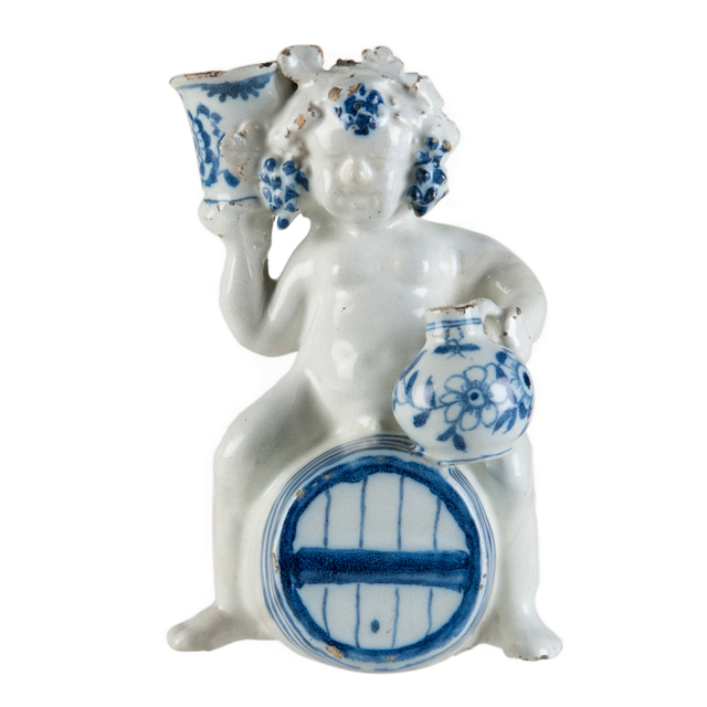 A Blue and White Dutch Delft Bacchus on Wine Barrel
