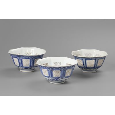 A set of three matching octagonal reticulated blue and white bowls