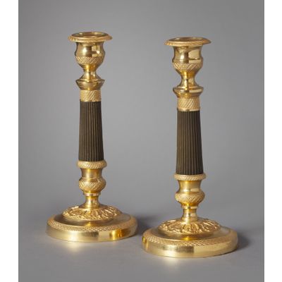 A pair of ormolu and bronze Charles Dix candlesticks