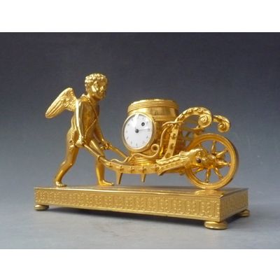 Attractive small mantel clock / pendulette, Amor  with wheelbarrow, Austria circa 1810.