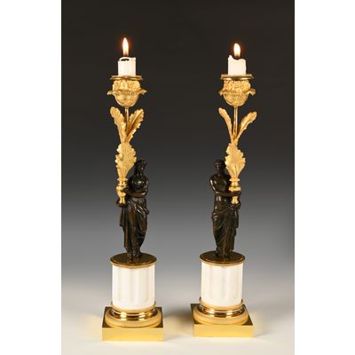 A pair of ormolu and patinated bronze candlesticks