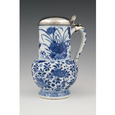 A Chinese porcelain jug with silver lid