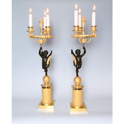 A pair of French Empire patinated bronze and ormolu candelabras