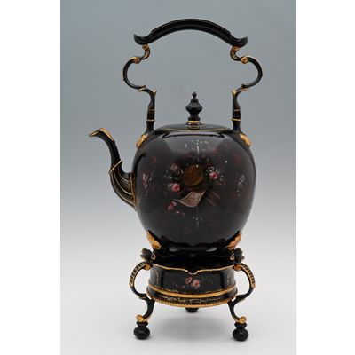 A  pewter bouilloire on a stand