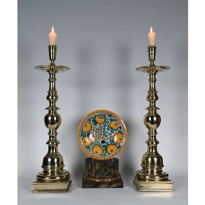 A rare pair of large brass candlesticks with square bases.