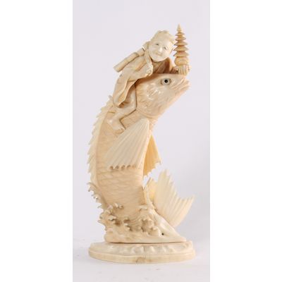 'Man on a Carp', a Japanese carved ivory sculpture, circa 1880