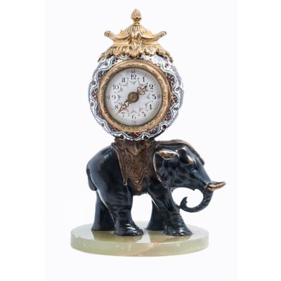 Cute miniature time piece pendulum of a bronze elephant carrying the movement 