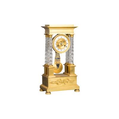 An attractive Charles X ormolu and crystal portico striking 8-day mantel clock