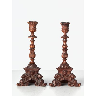 A small pair of Italian highly carved walnut single candlesticks, circa 1850