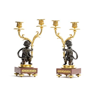 Napoleon III period candlesticks on a red marble decorated base featuring young kids carrying the candles