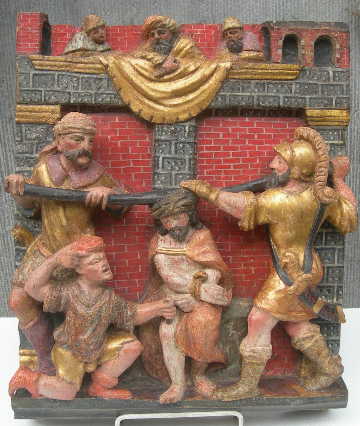 A POLYCHROME CARVED WOODEN RELIEF  1 of 2