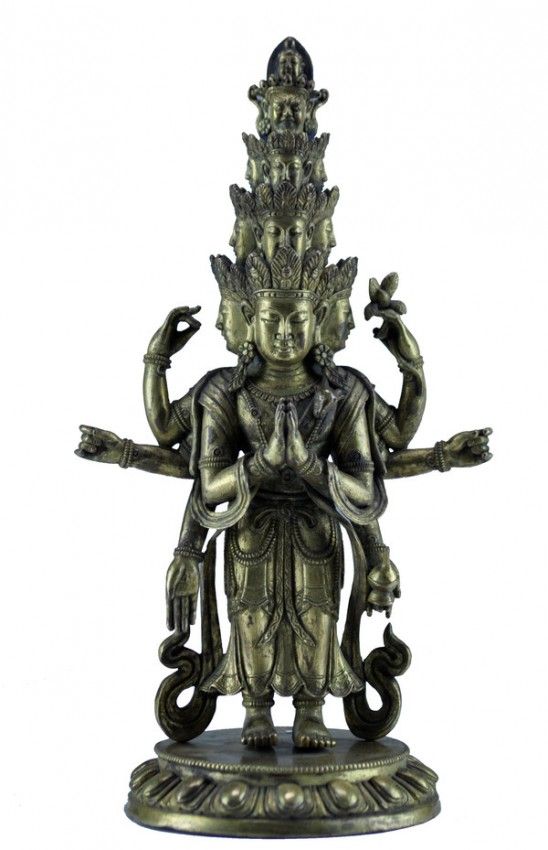 A GILT-BRONZE FIGURE OF AN ELEVEN-HEADED AVALOKITESVARA 