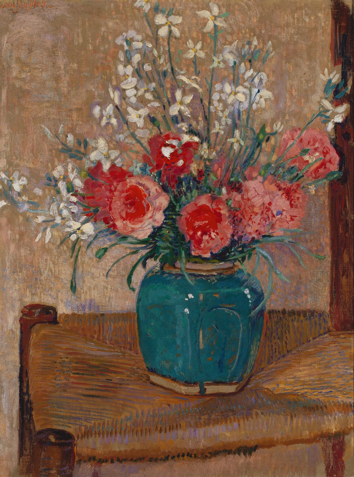 Flowers in a pot on a cane chair