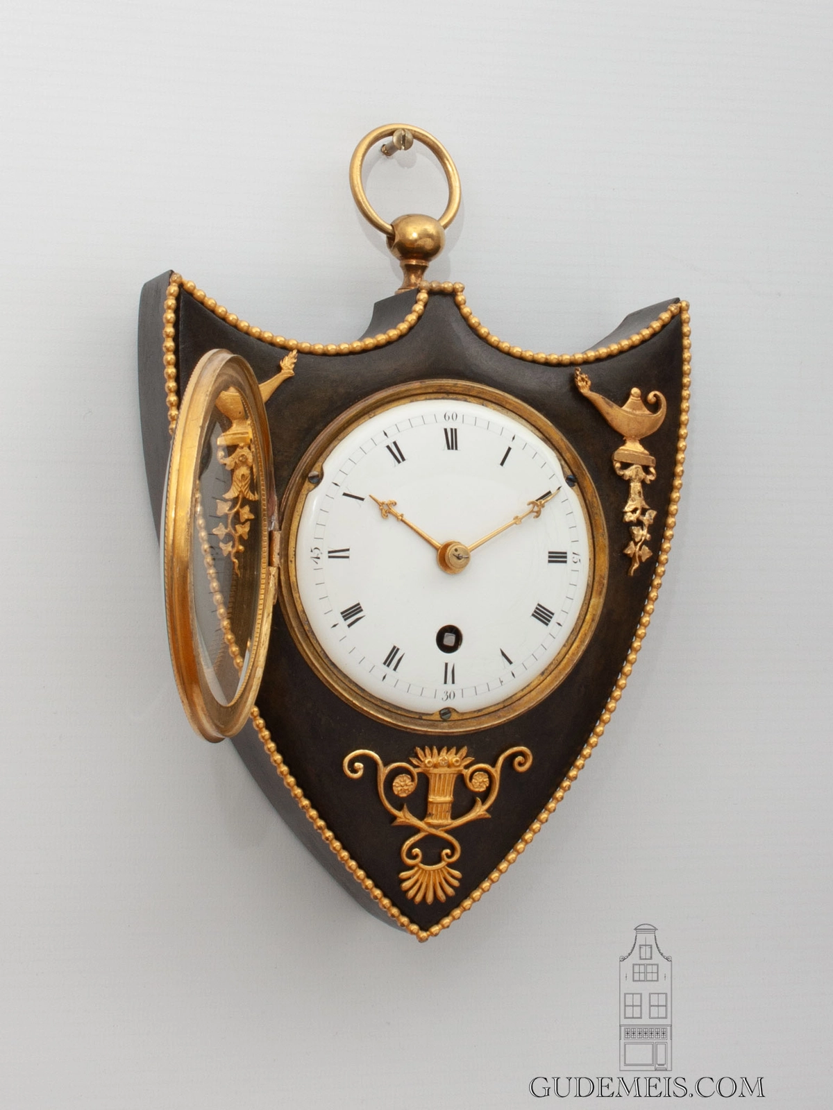 A rare and small French Empire bronze cartel wall clock, circa 1810.