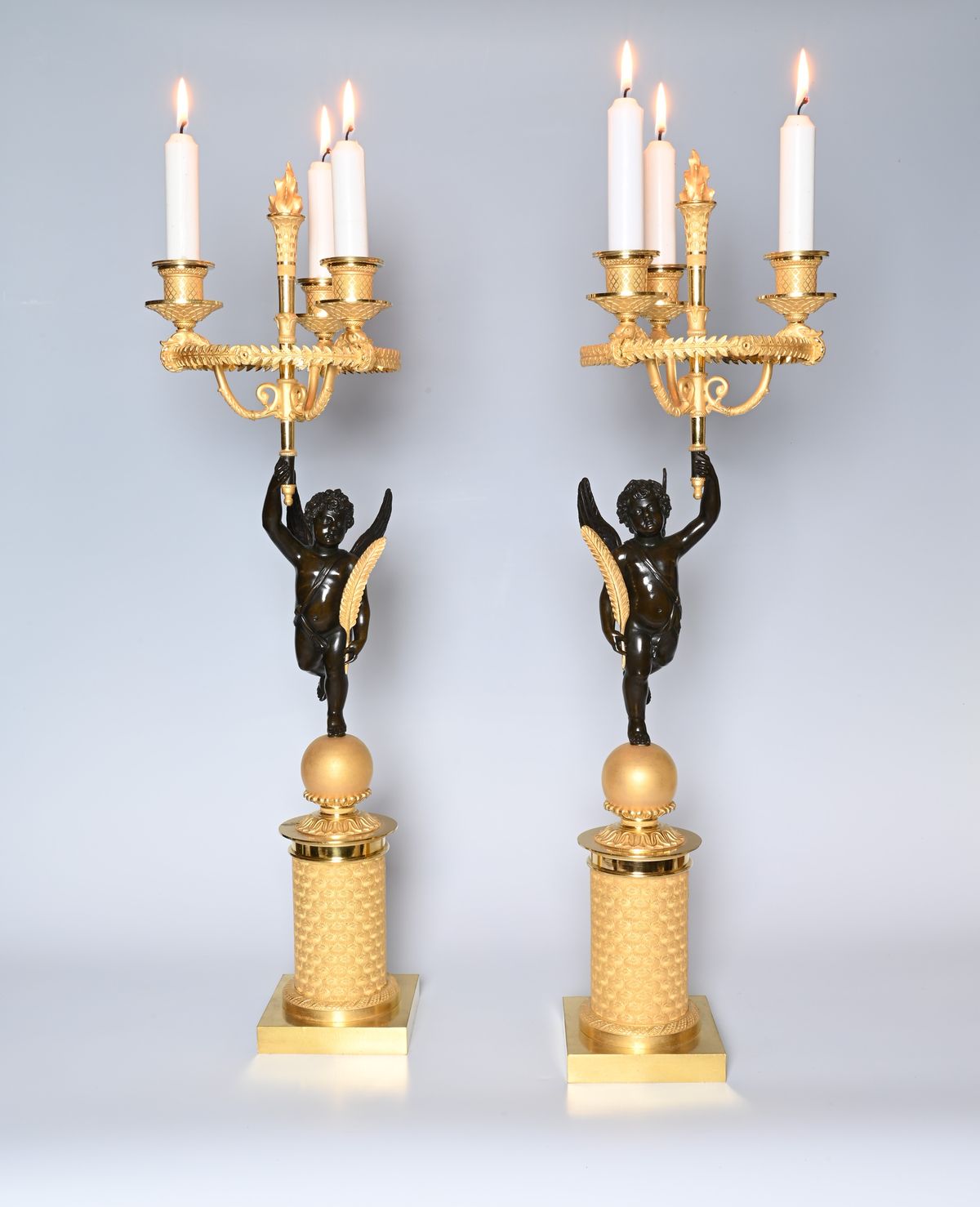 A pair of French Empire patinated bronze and ormolu candelabras - image 1