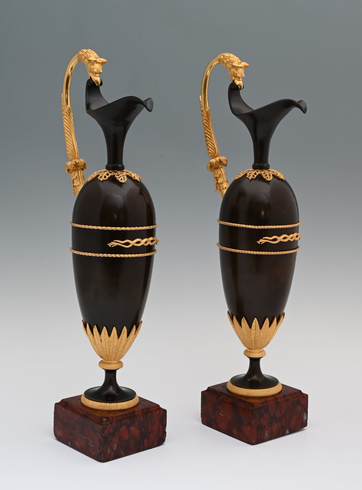 A pair of French Empire patinated bronze and ormolu ewers - image 1