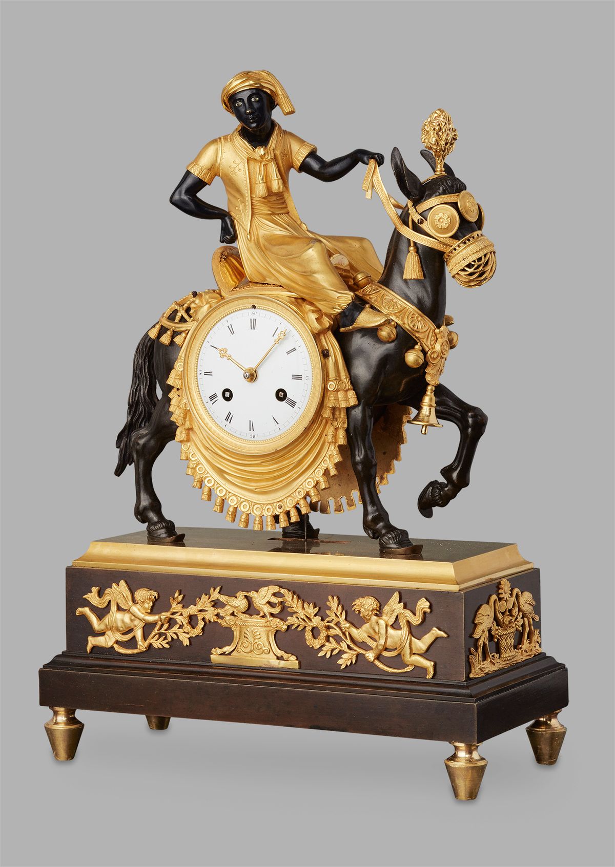 An unusual French ‘Directoire' gilt and patinated bronze mantel clock with young Arab on mule, circa 1800 - image 1