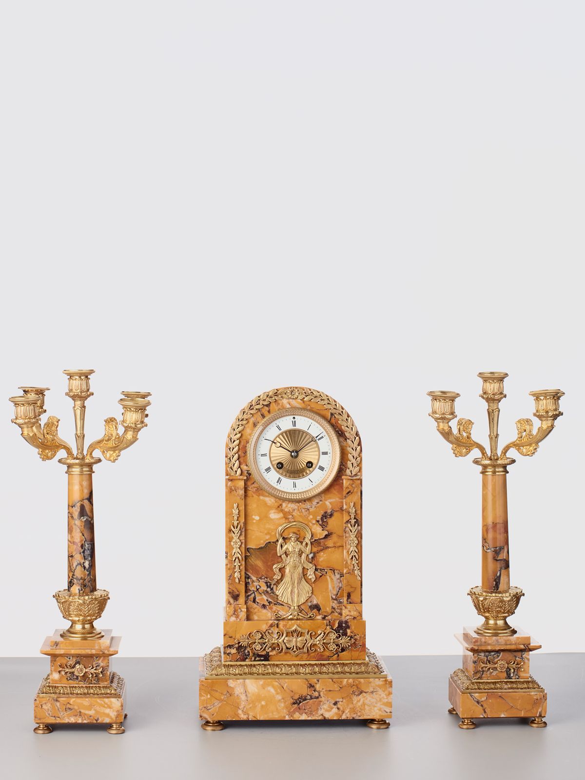 A French sienna marble clock with candle holders, circa 1890 - image 1