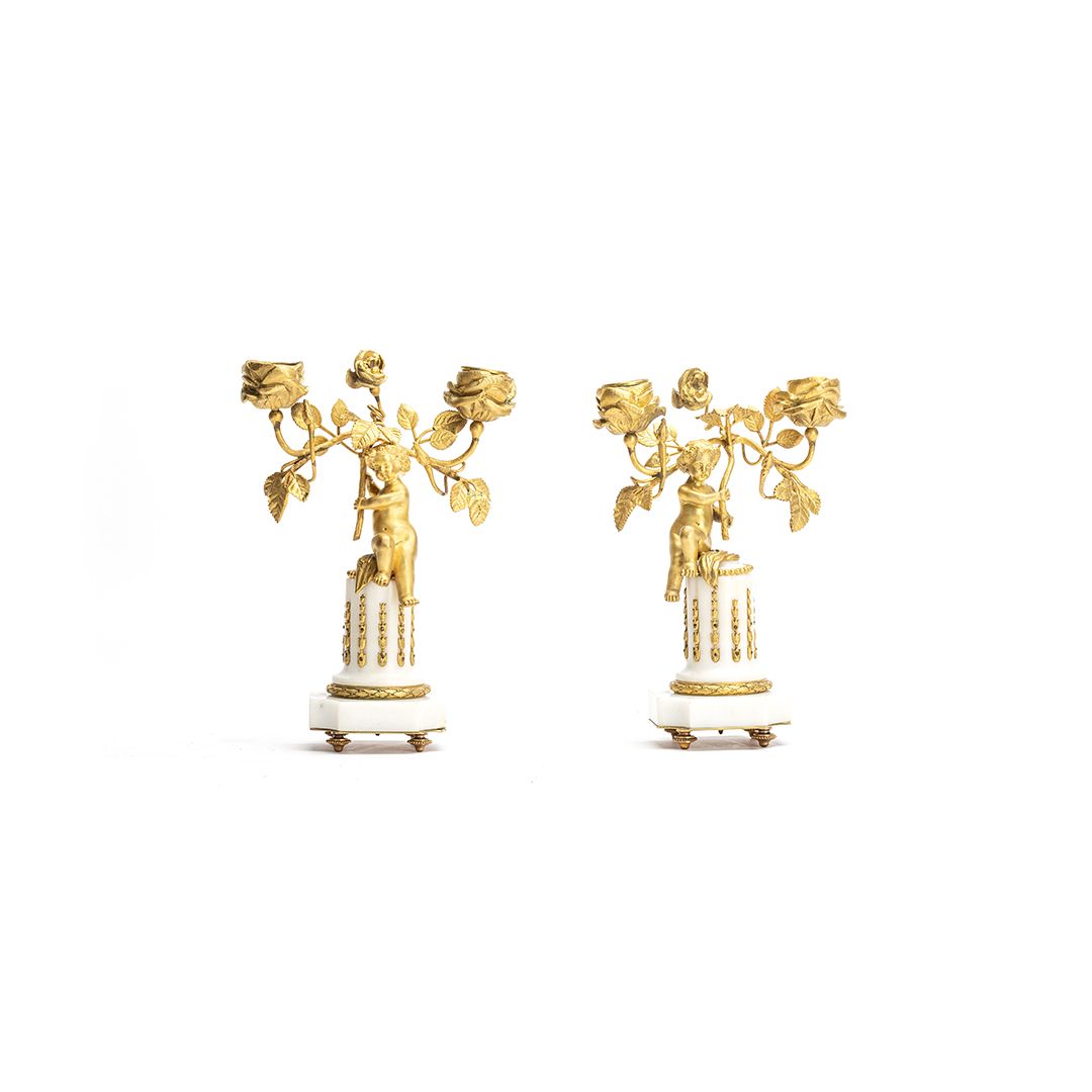 A cute pair of romantic small candlesticks featuring two small kids sitting on a white marble base - image 1