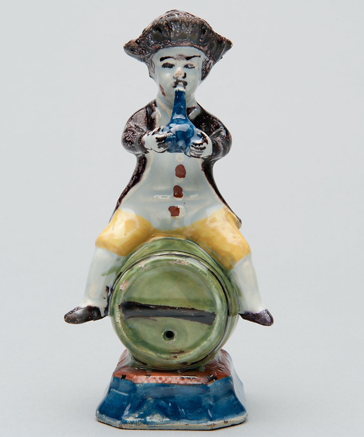 A Polychrome Figure of a Fellow Seated on a Barrel in Dutch Delftware - image 1