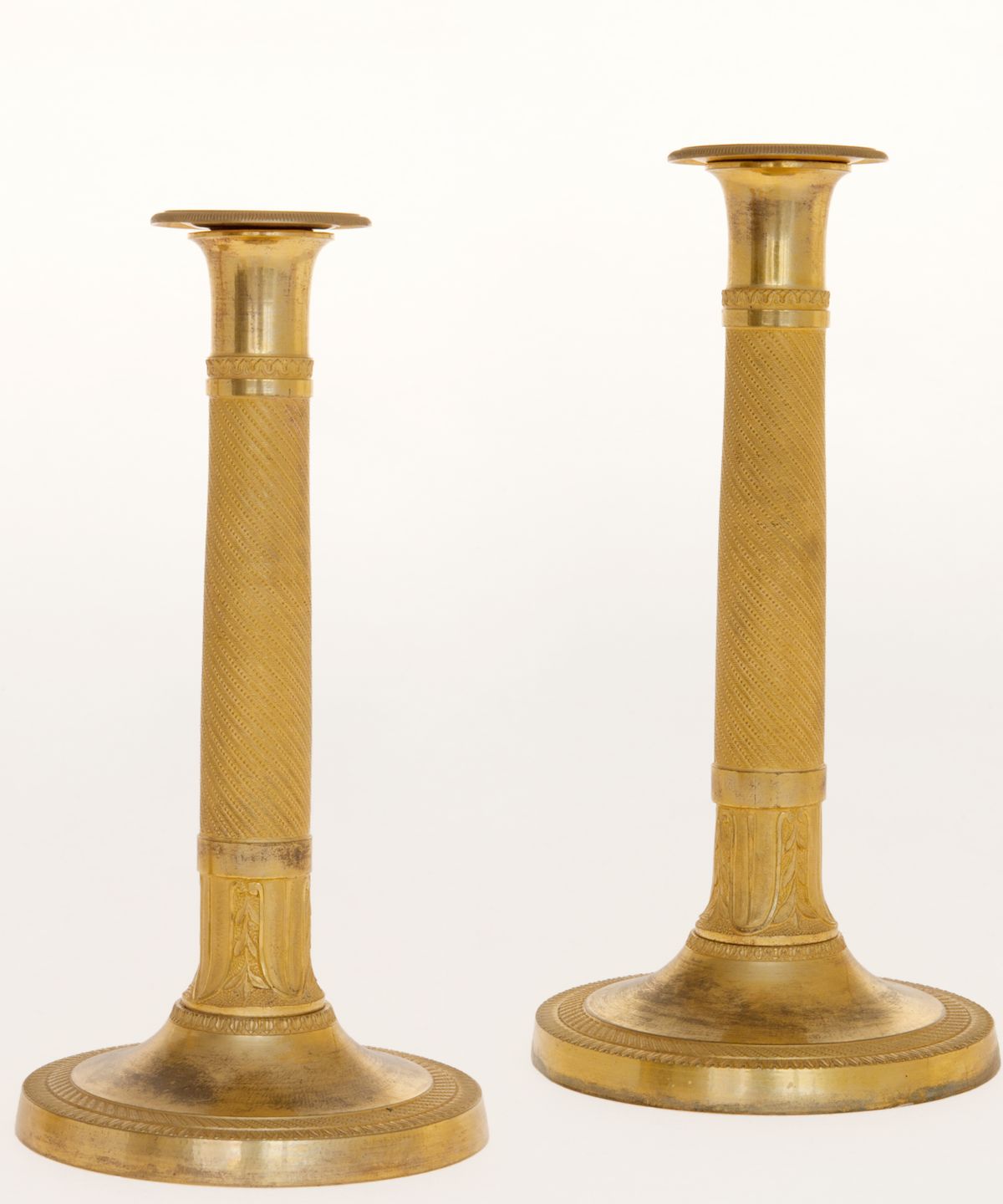 A Pair of Empire Candlesticks in Guilded Bronze