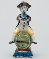 A Polychrome Figure of a Fellow Seated on a Barrel in Dutch Delftware - image 1