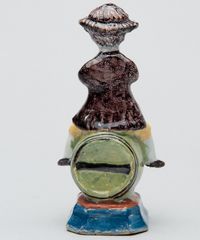 A Polychrome Figure of a Fellow Seated on a Barrel in Dutch Delftware - image 2