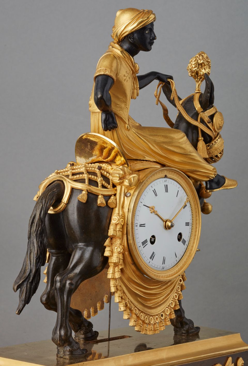 An unusual French ‘Directoire' gilt and patinated bronze mantel clock with young Arab on mule, circa 1800 - image 2