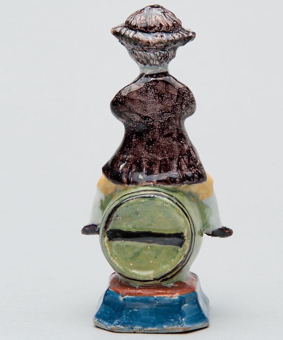 A Polychrome Figure of a Fellow Seated on a Barrel in Dutch Delftware - image 2